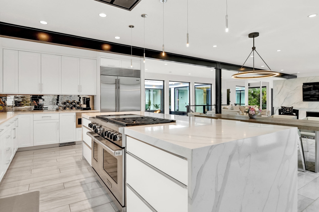 quartz-waterfall-countertop-white-kitchen-wolf-appliances-ultra-modern-1100x733.jpg