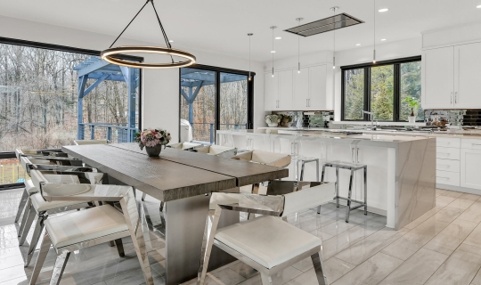 Large white kitchen remodel renovation open to modern dining space