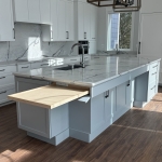 Pullout kitchen island shelf, hidden in island behind false drawer front